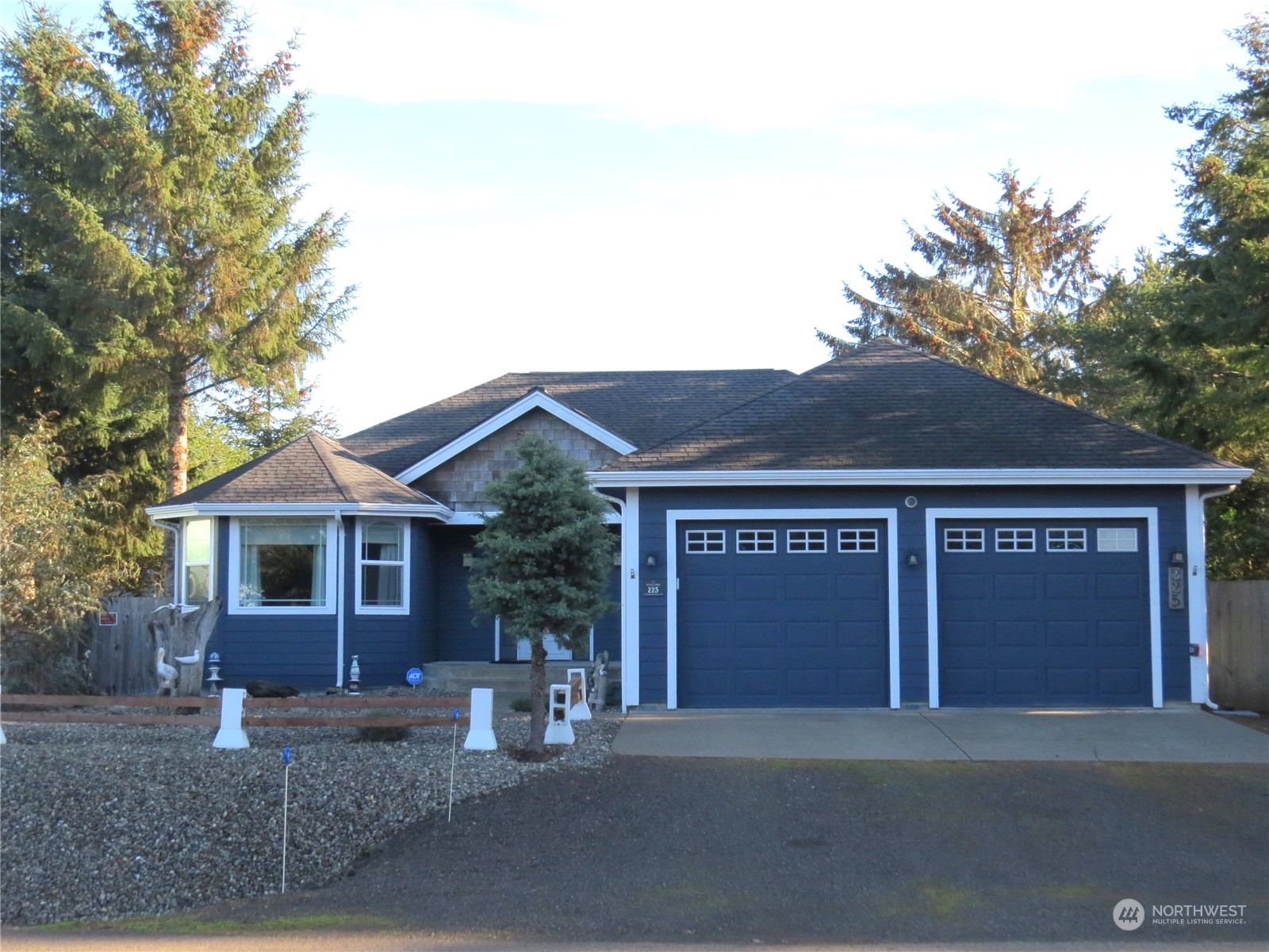 a front view of a house with yard garage and garage