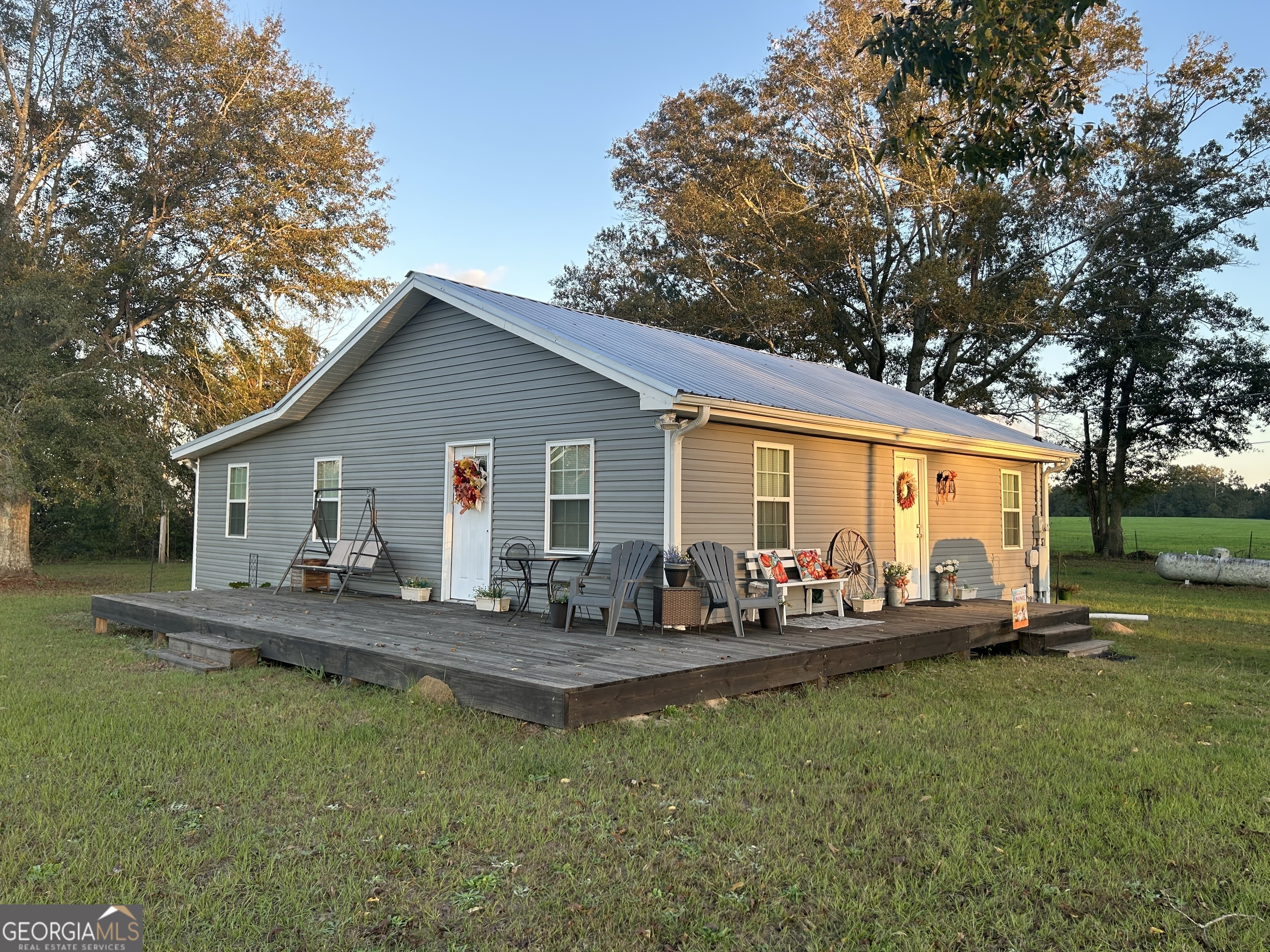 a front view of house with yard patio and fire pit