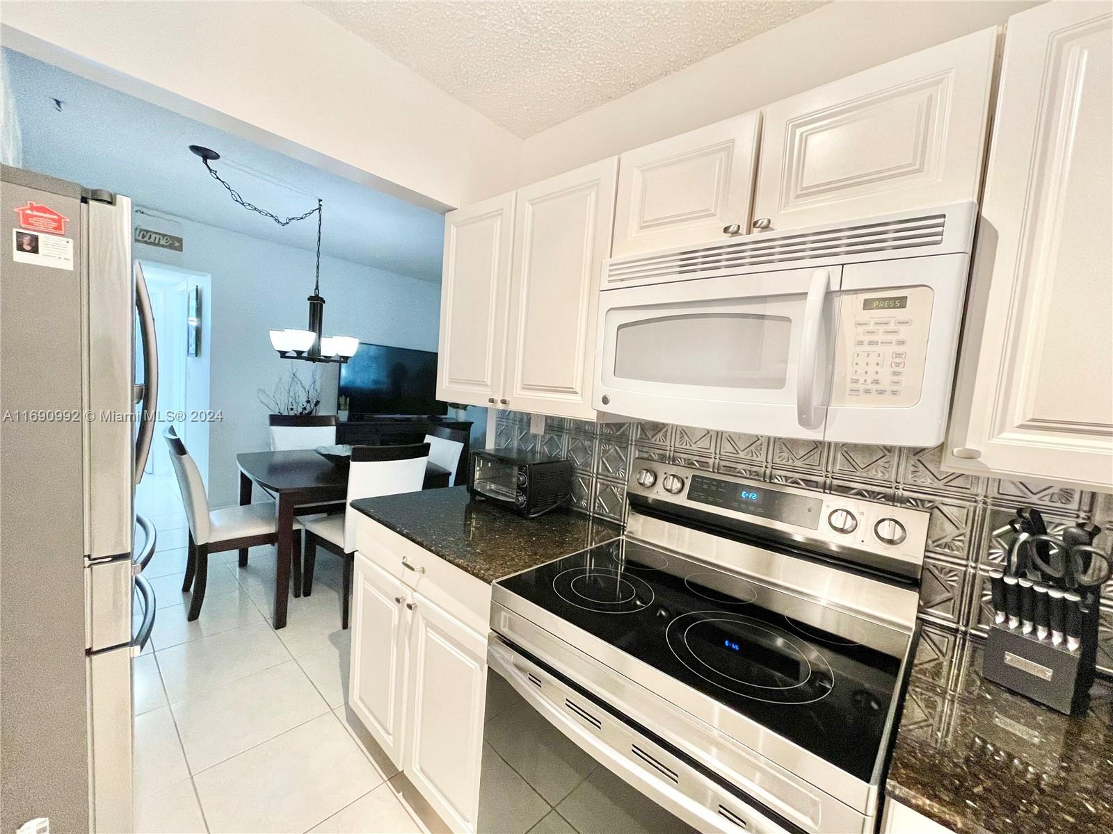 a kitchen with a stove and a refrigerator