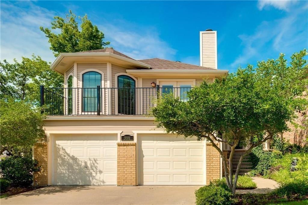 a front view of a house with plants