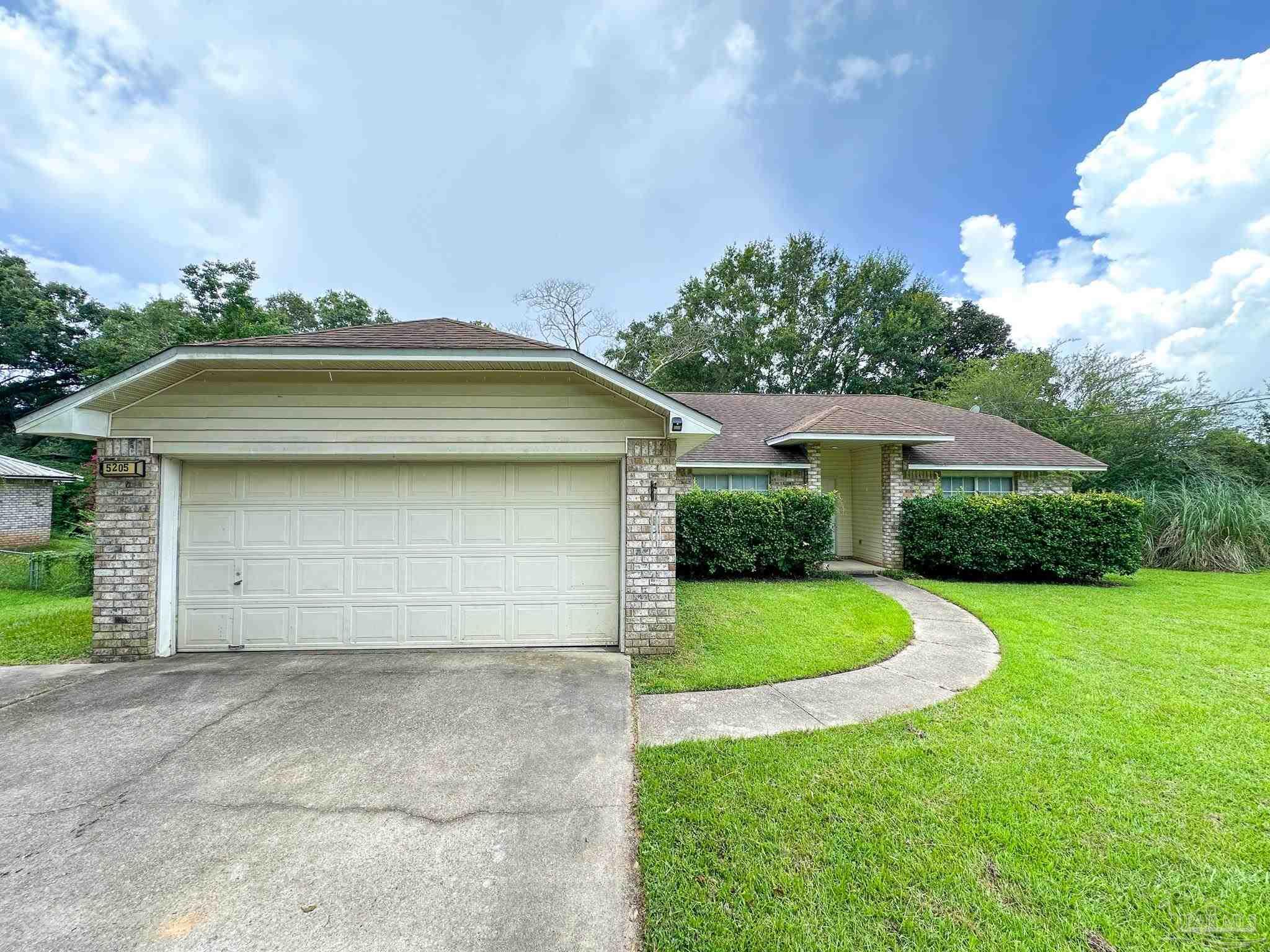 a view of a house with a yard and garage