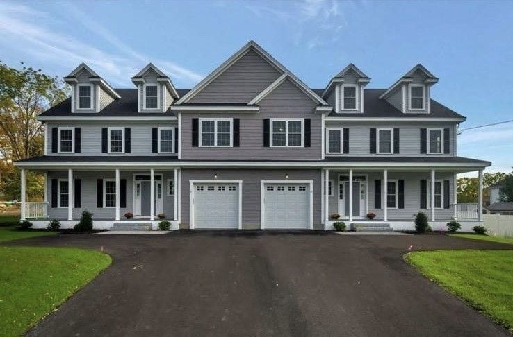 a front view of a residential apartment building with a yard