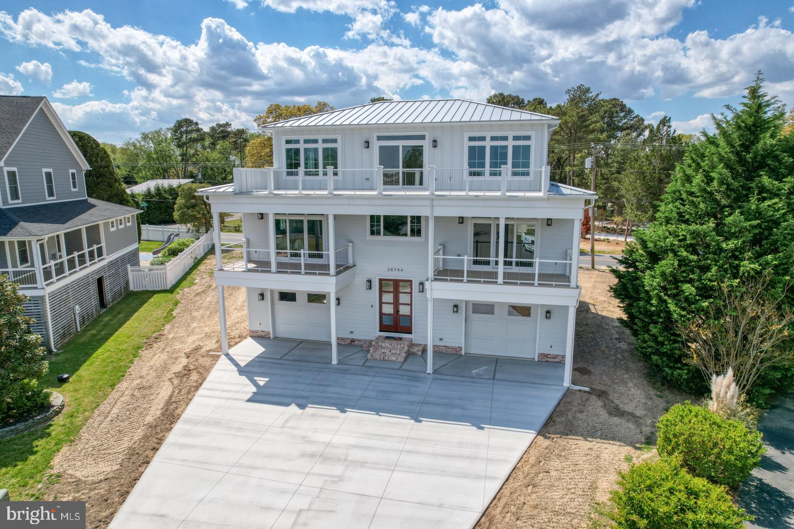 a view of a house with backyard porch and sitting area