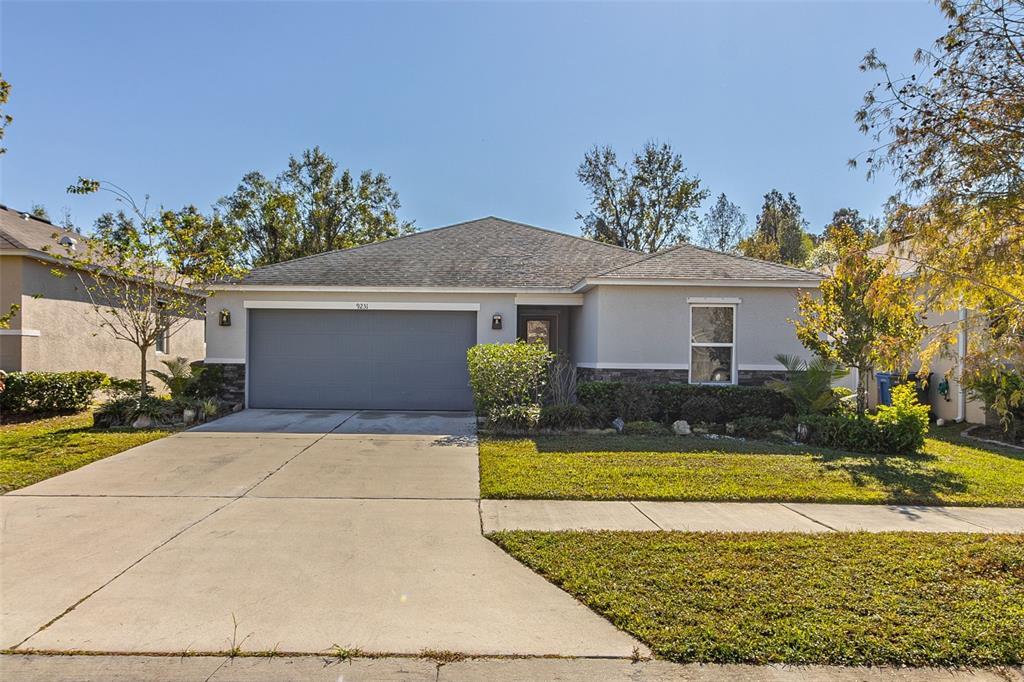 a front view of a house with a yard and garage