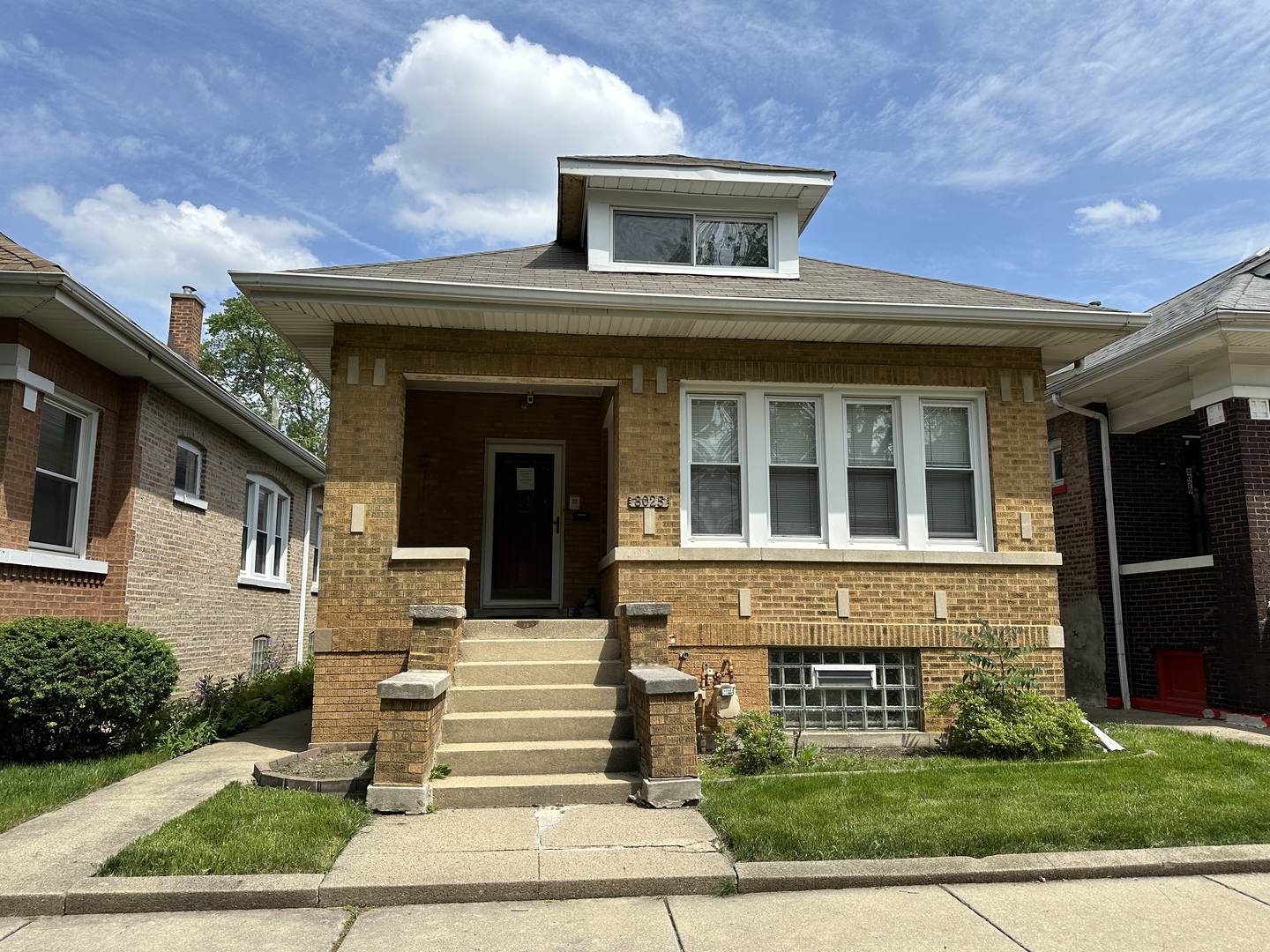 a front view of a house with a garden