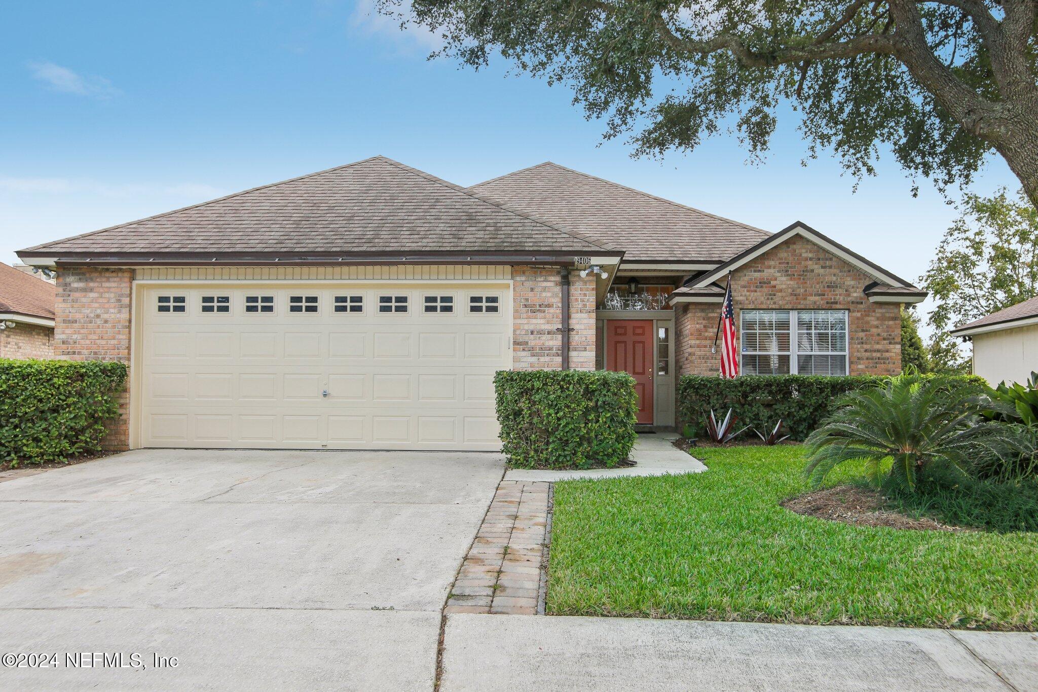 a front view of a house with a yard and garage