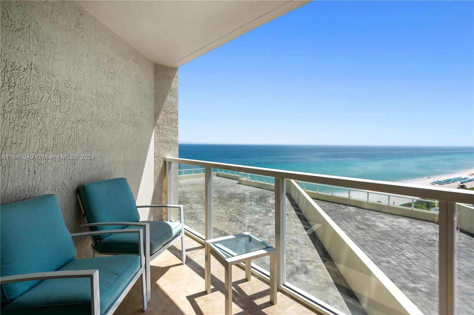 a view of balcony with wooden floor and furniture