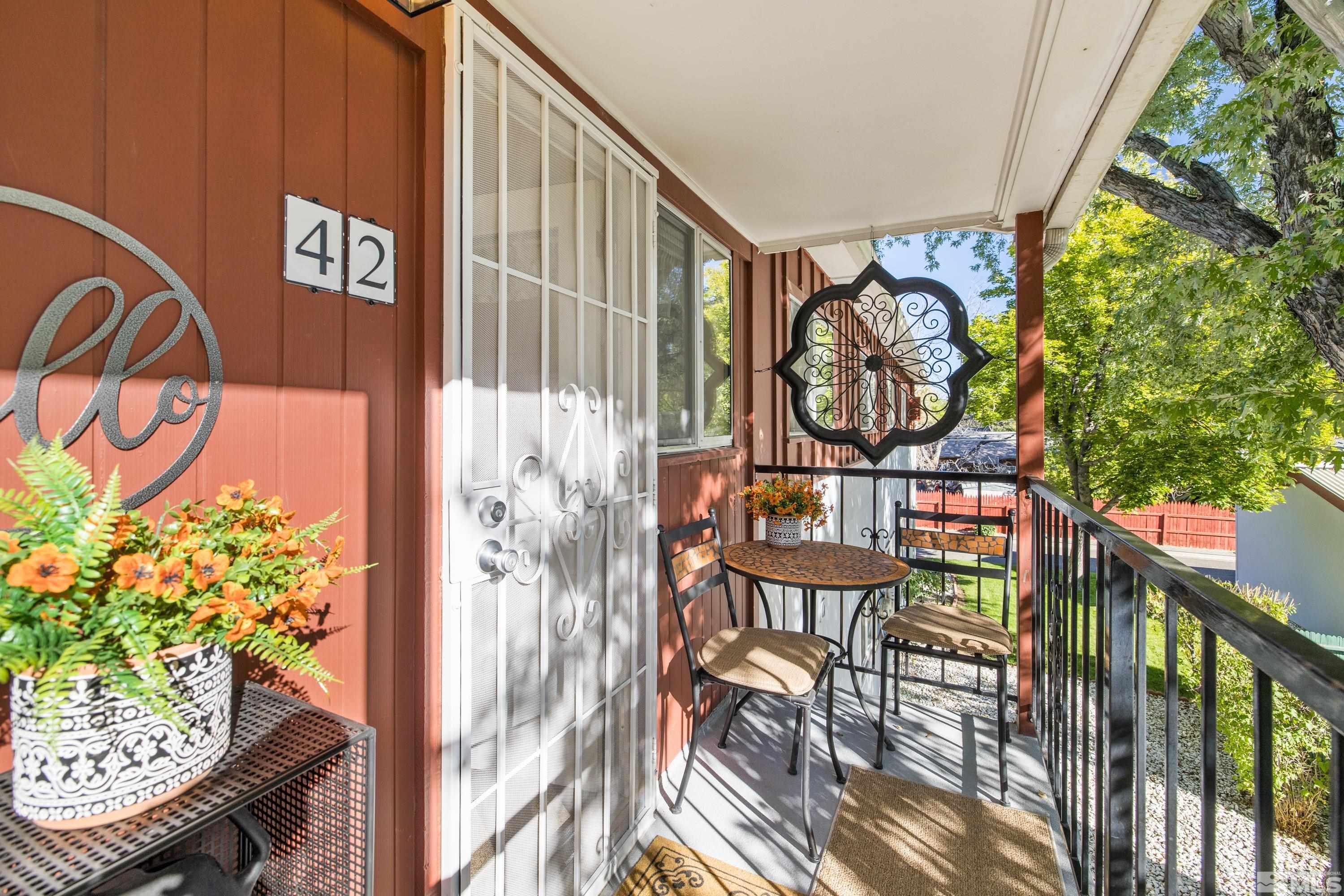 a view of a chairs and table in a balcony