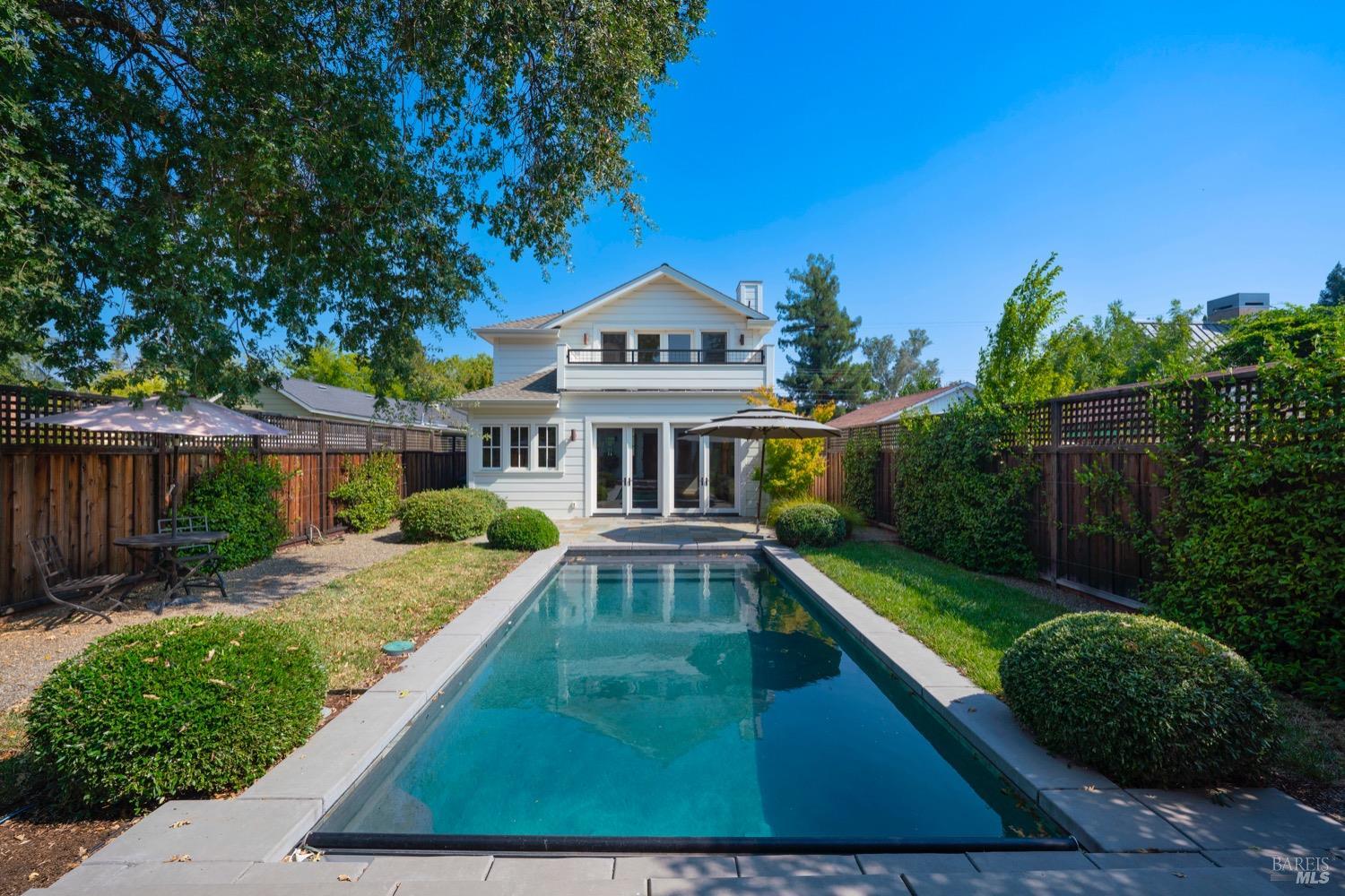 a view of a house with backyard and sitting area