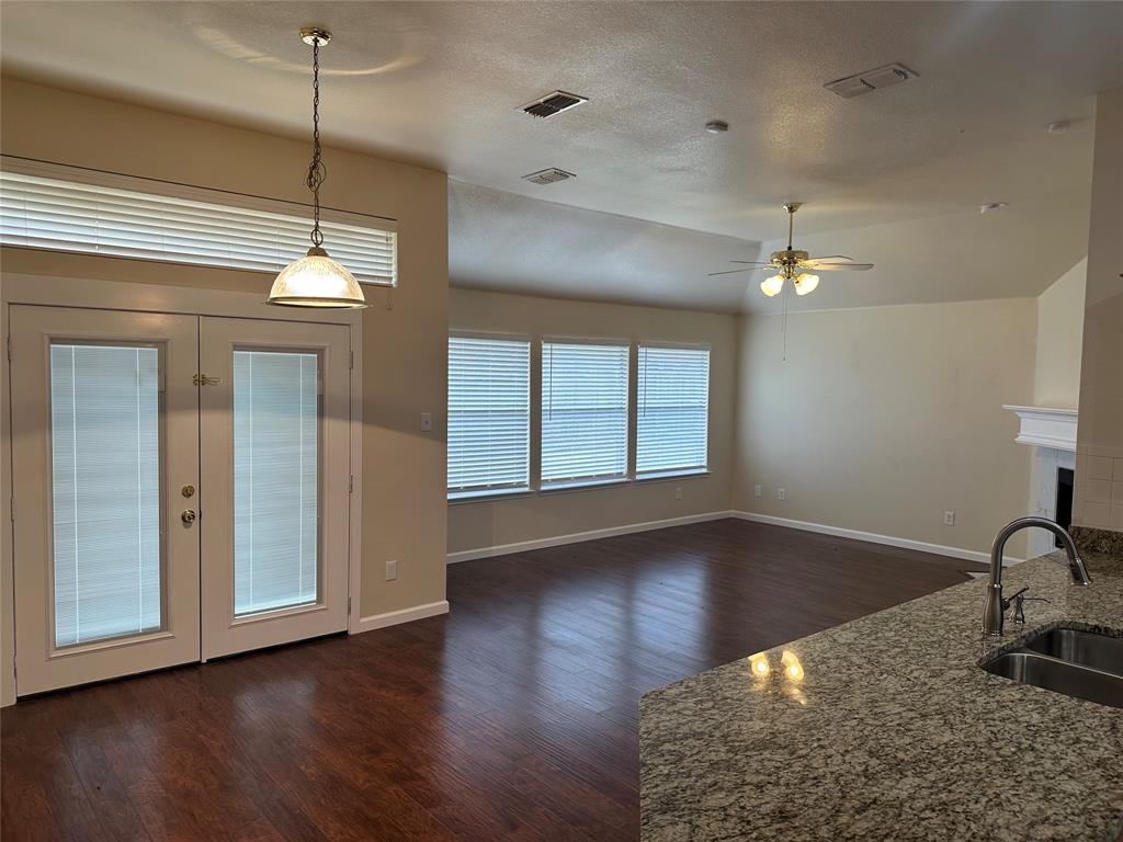 a view of a livingroom with a hardwood floor and a ceiling fan