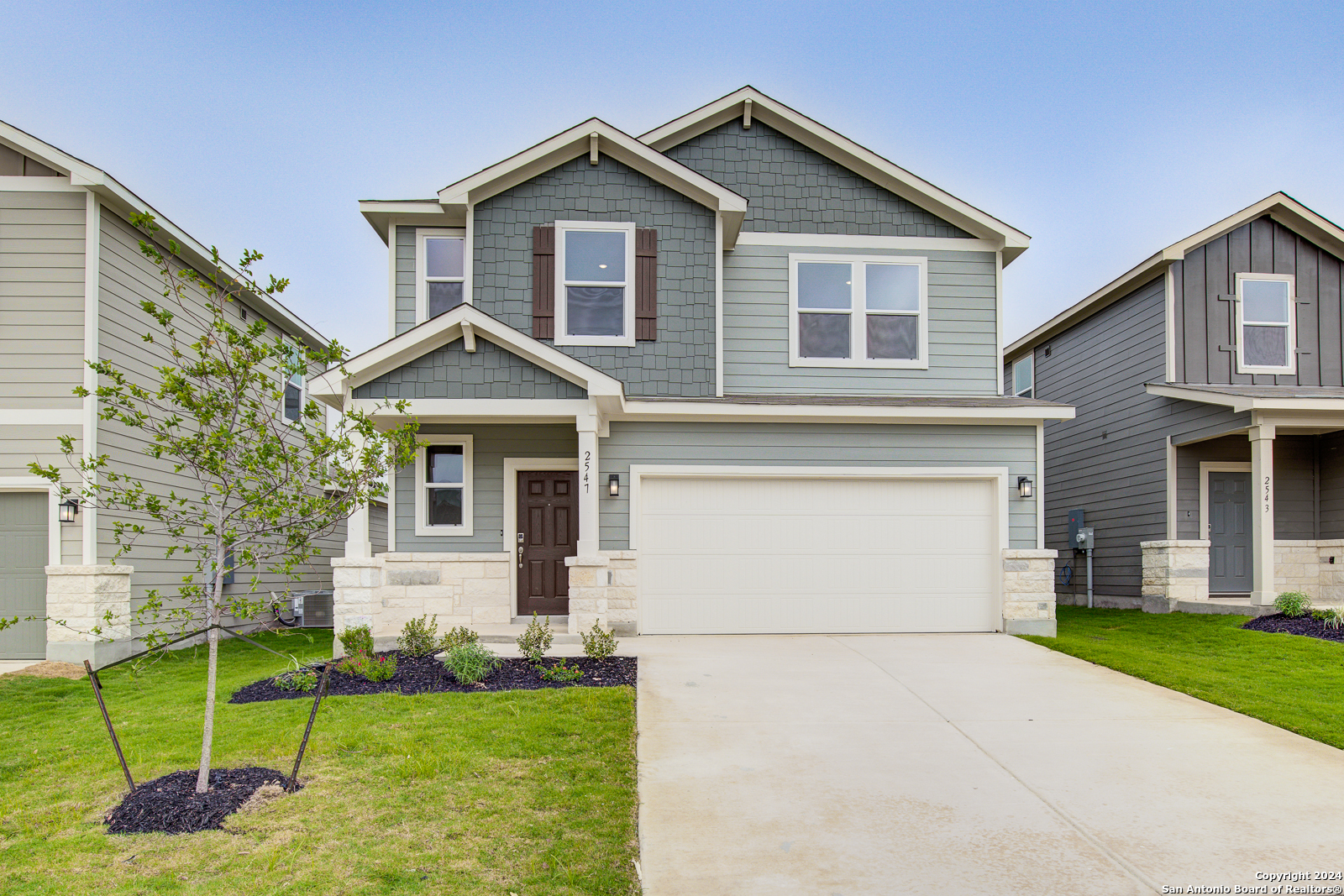 a front view of a house with a yard