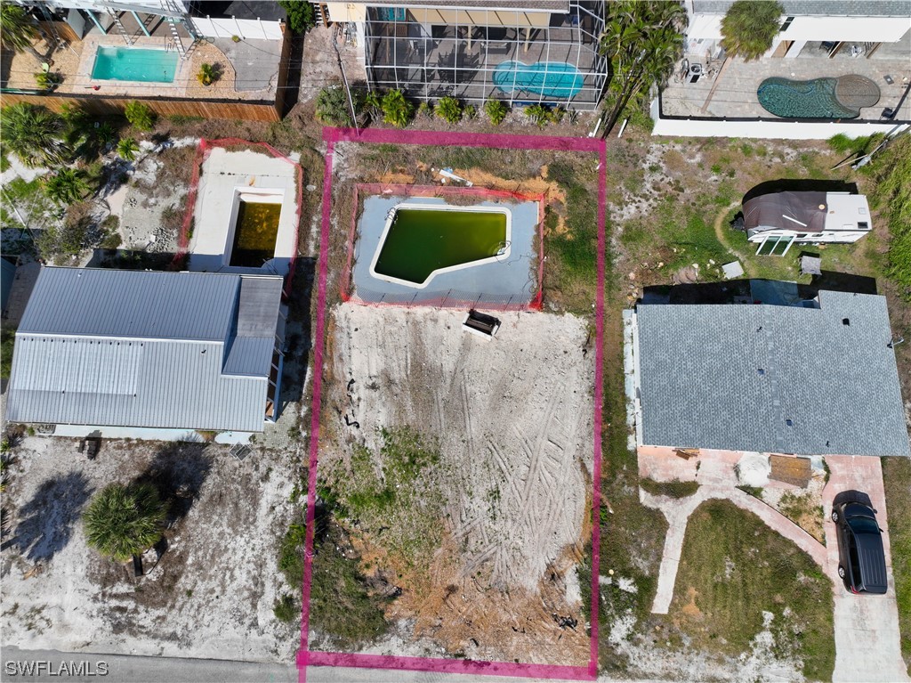 an aerial view of a house with a yard and a large tree