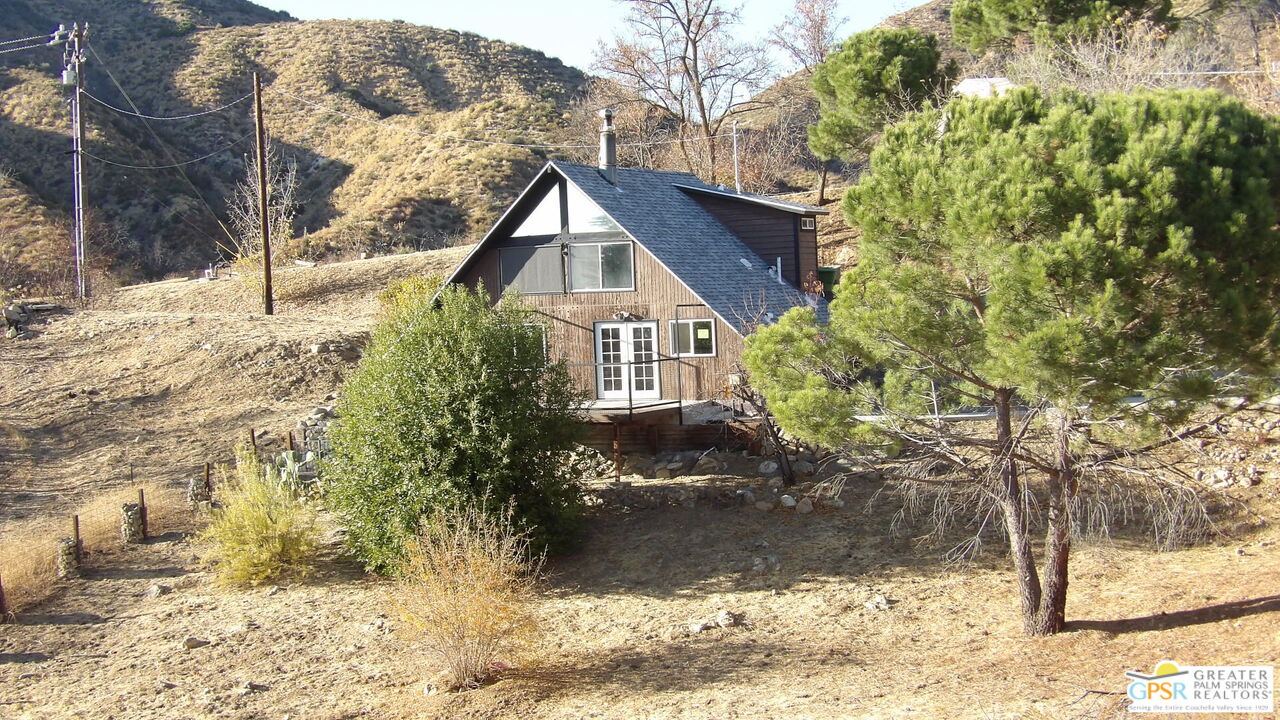 a front view of a house with a yard covered in snow