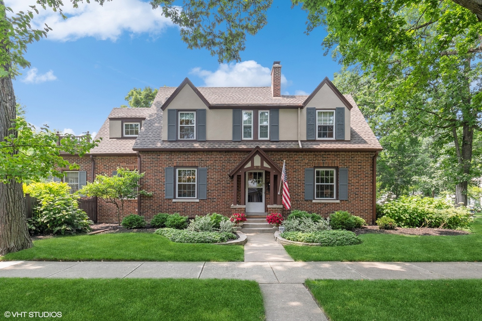 a front view of a house with a garden