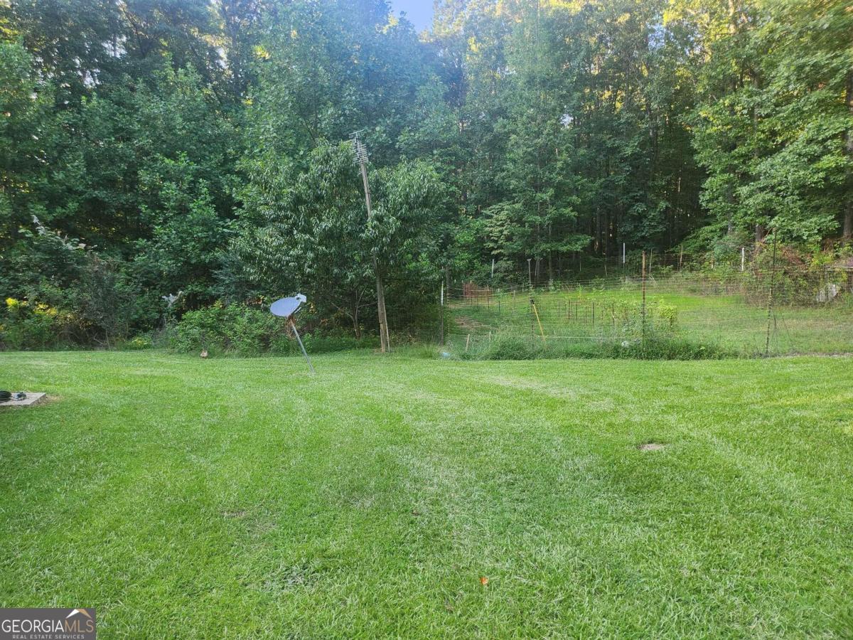 a view of outdoor space with green field and trees