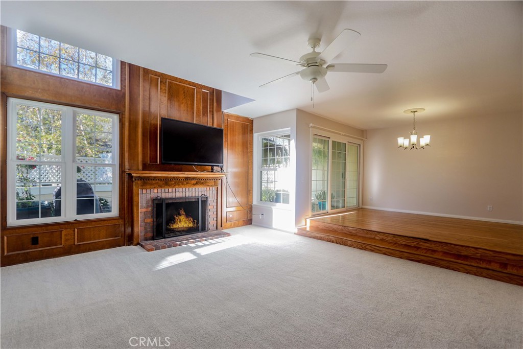 a living room with fireplace furniture and a flat screen tv