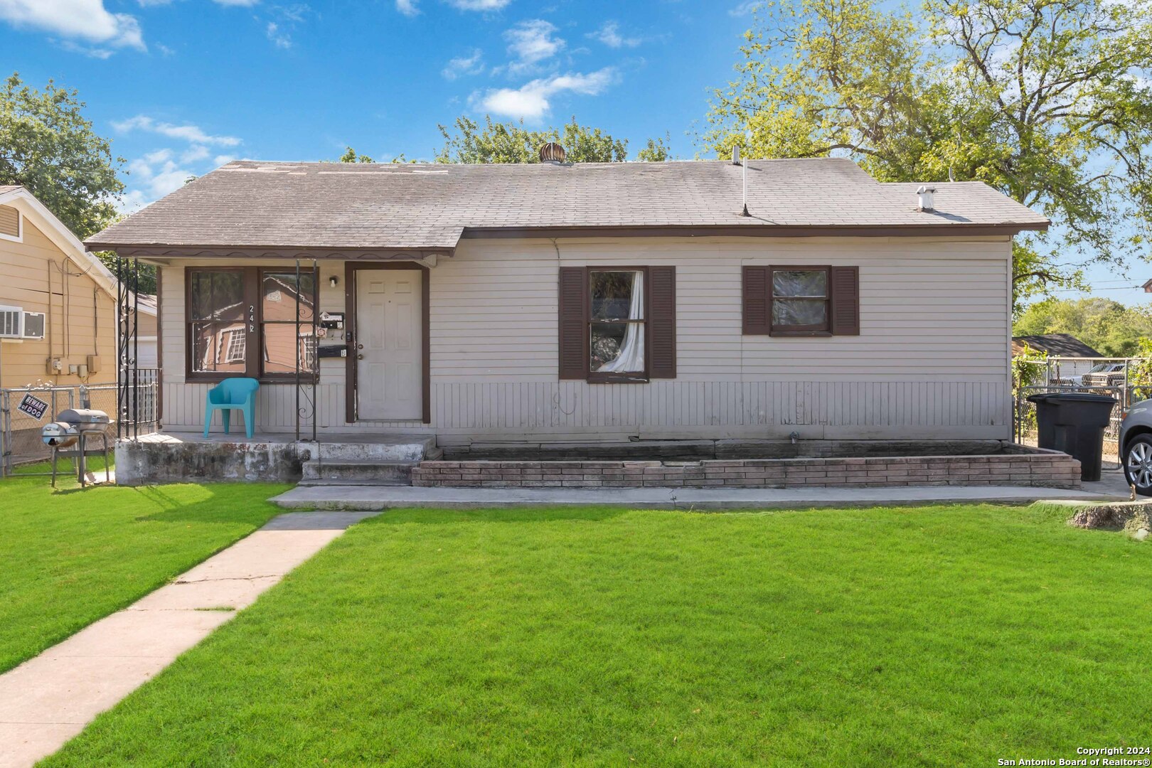 a front view of house with yard and outdoor seating