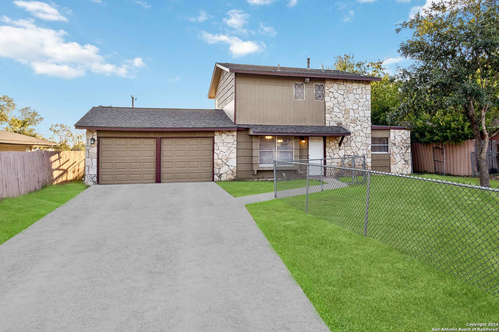 a front view of a house with a yard and garage