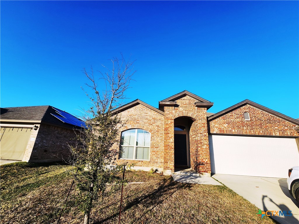 a front view of a house with a yard