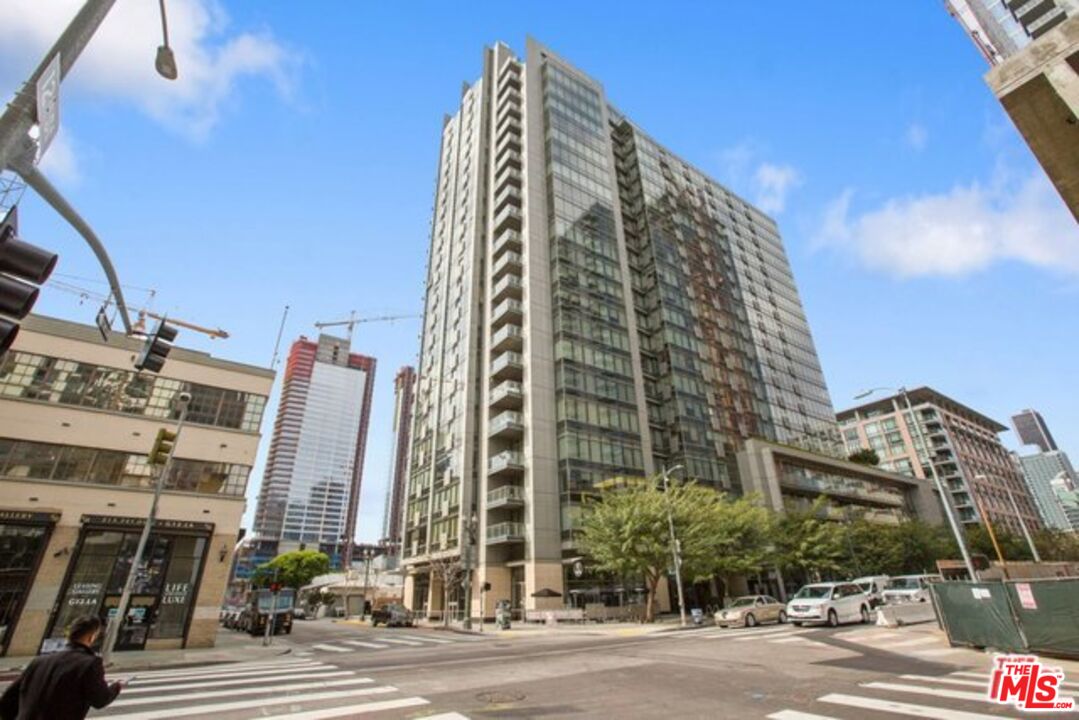 a view of a tall building next to a road