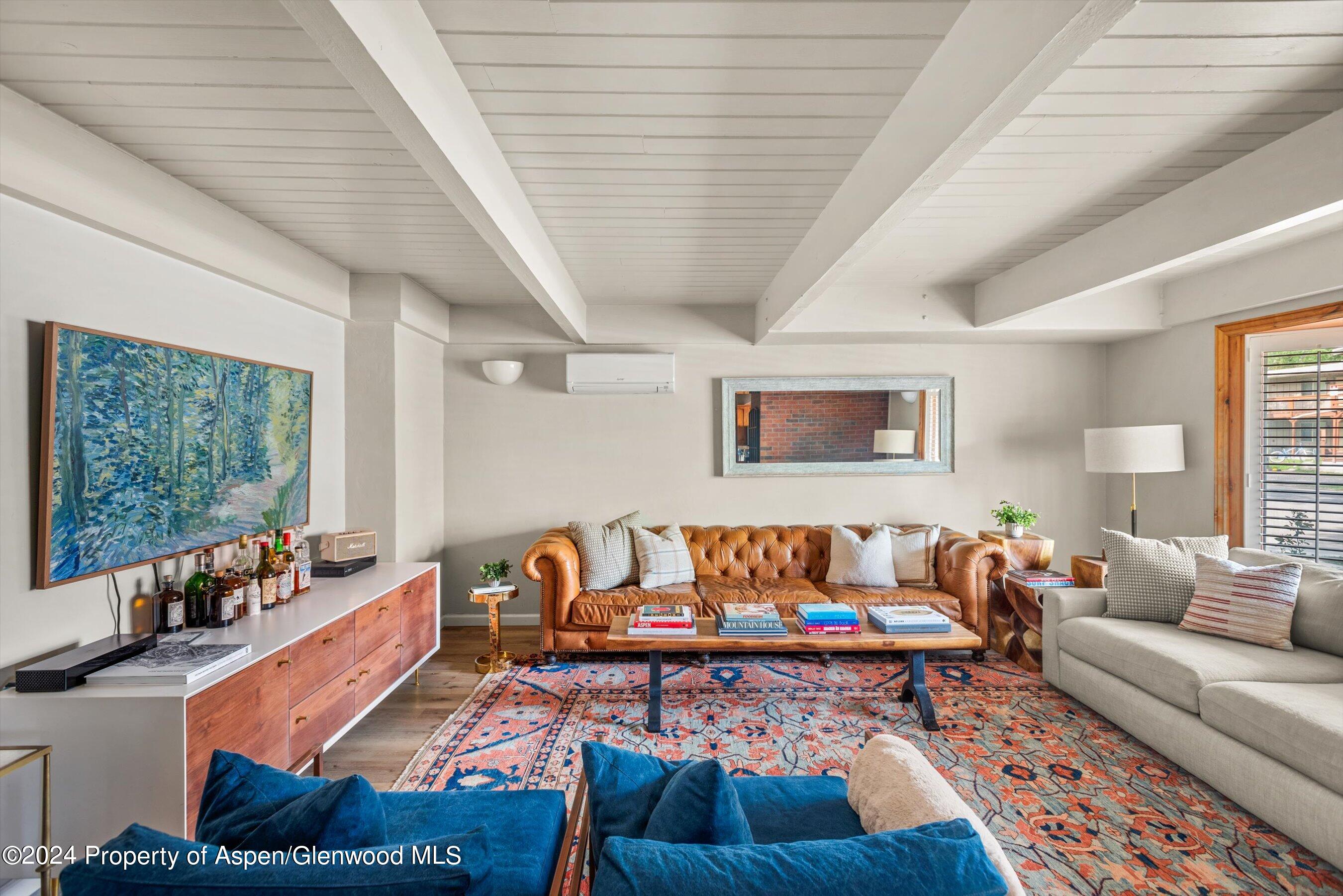 a living room with furniture and a rug