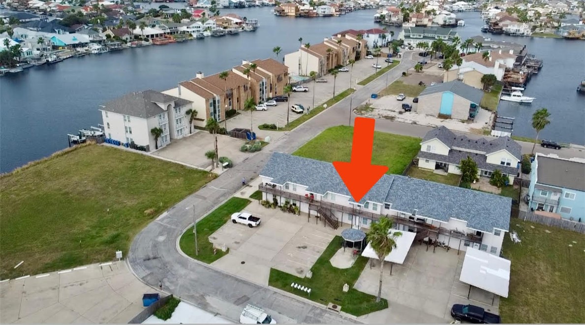 an aerial view of a house with a lake view