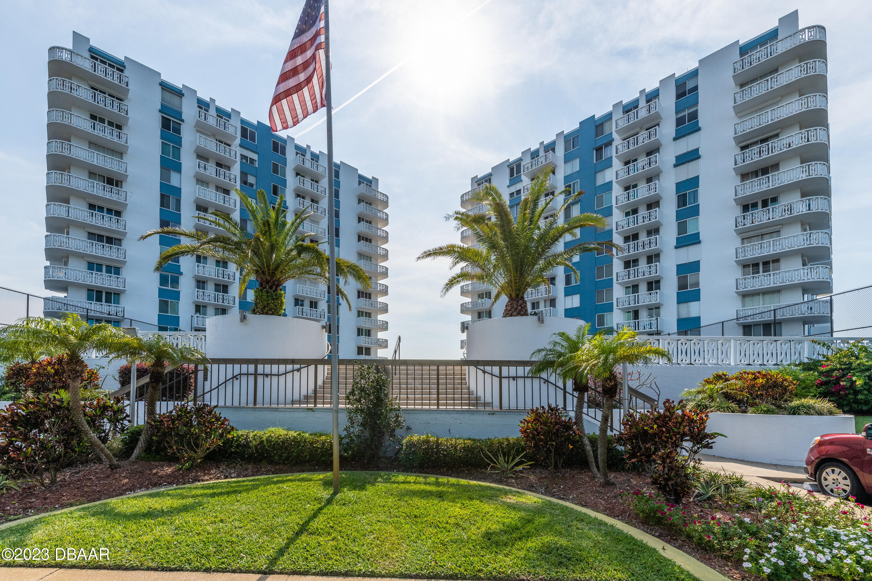 a view of a tall building and a yard