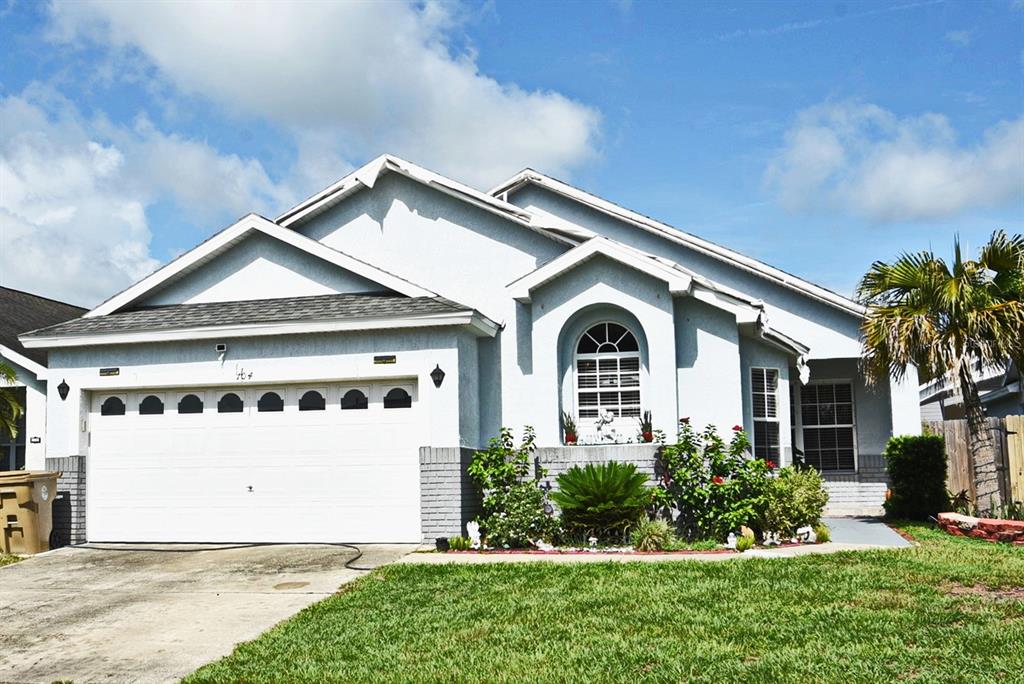 a front view of a house with a yard and garage