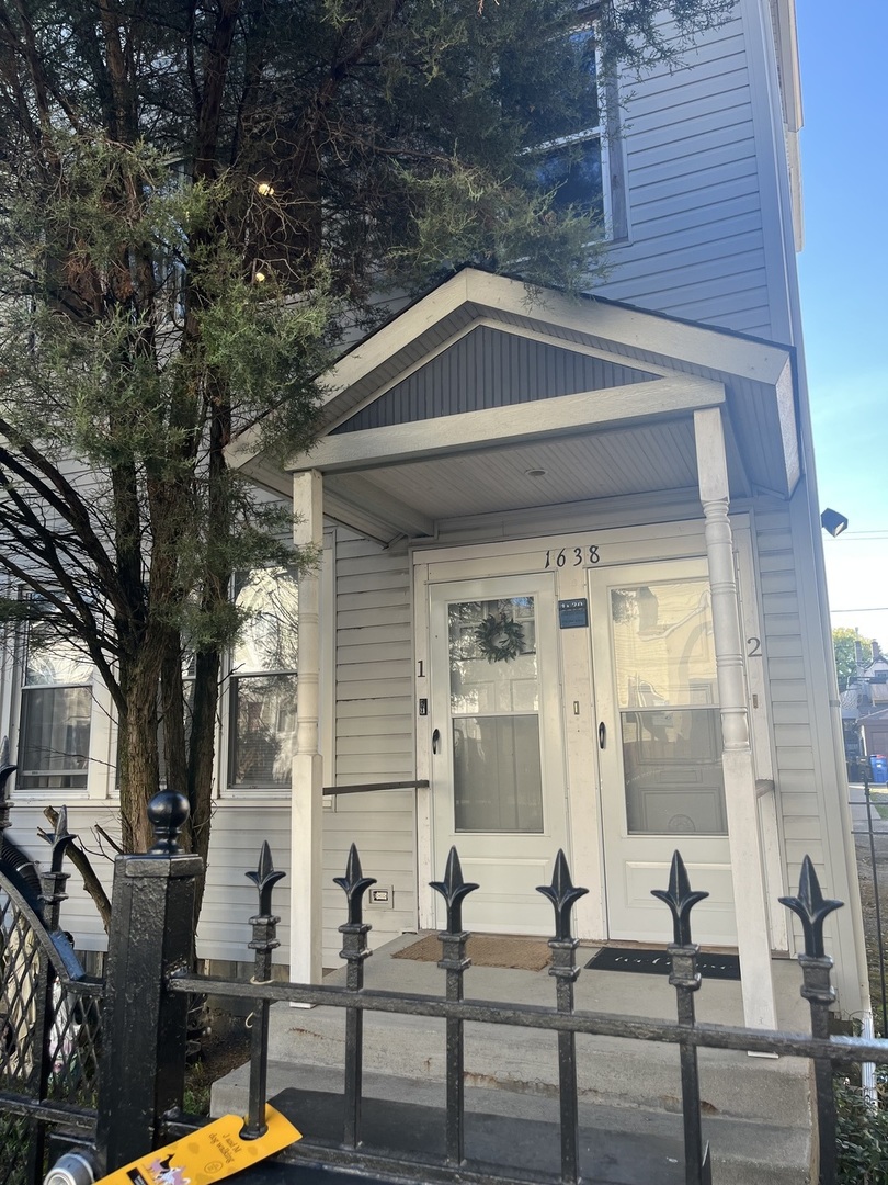 a front view of a house with outdoor seating