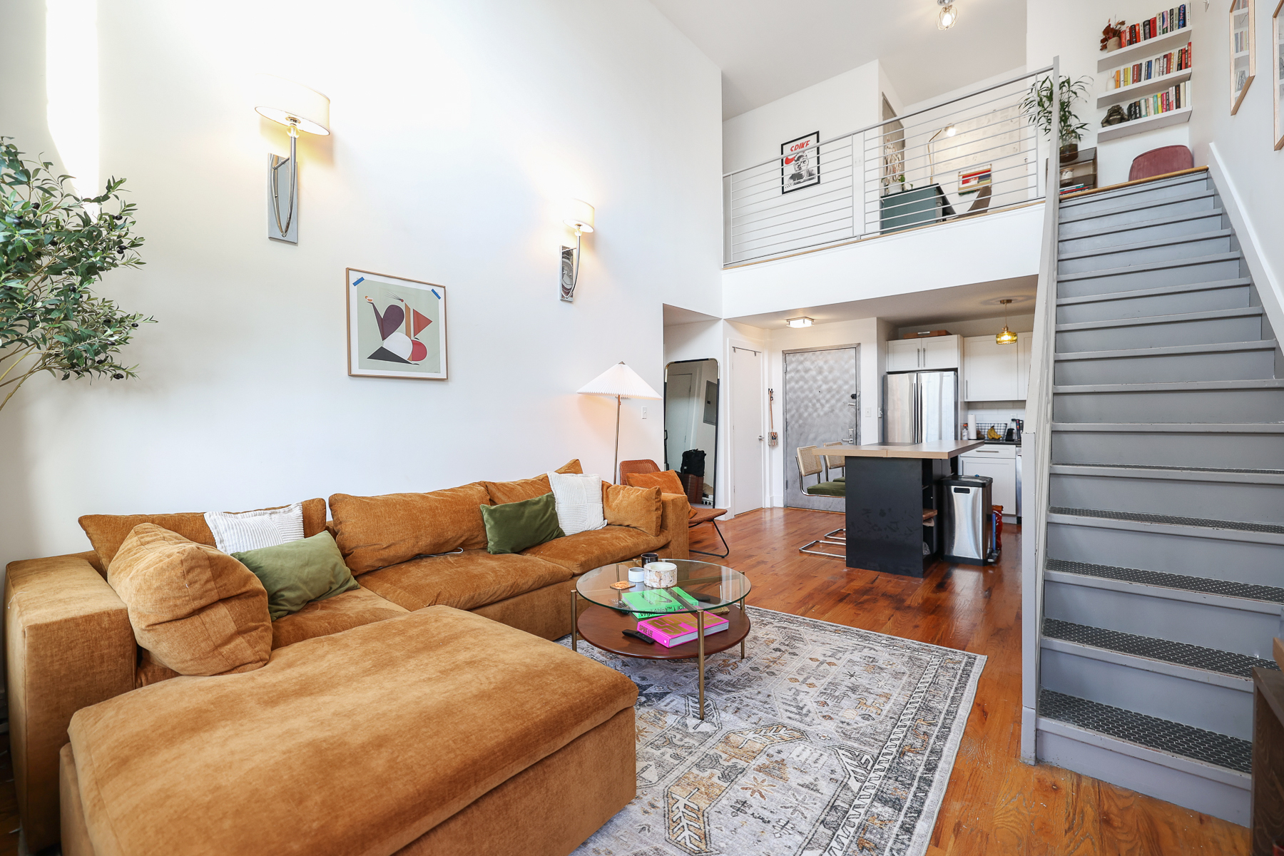 a living room with furniture and wooden floor