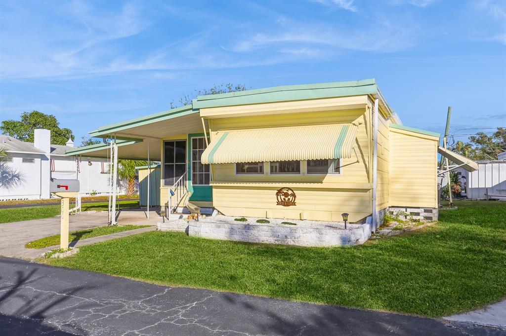 a view of a house with backyard porch and sitting area