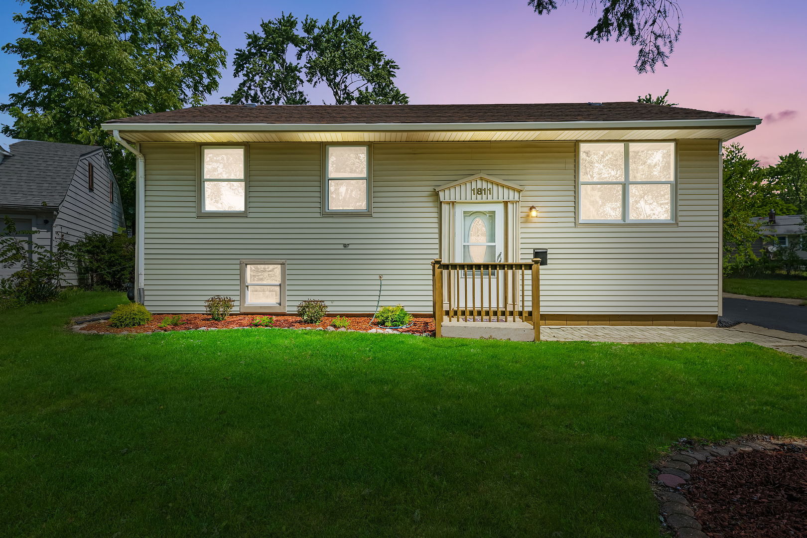 a front view of a house with a garden