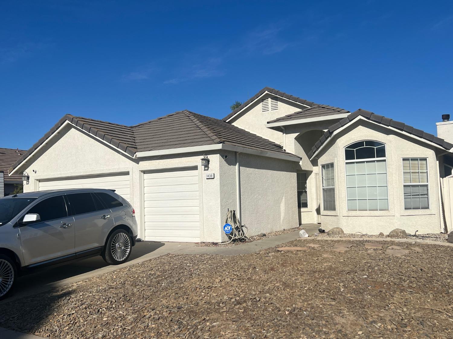 a front view of a house with parking space