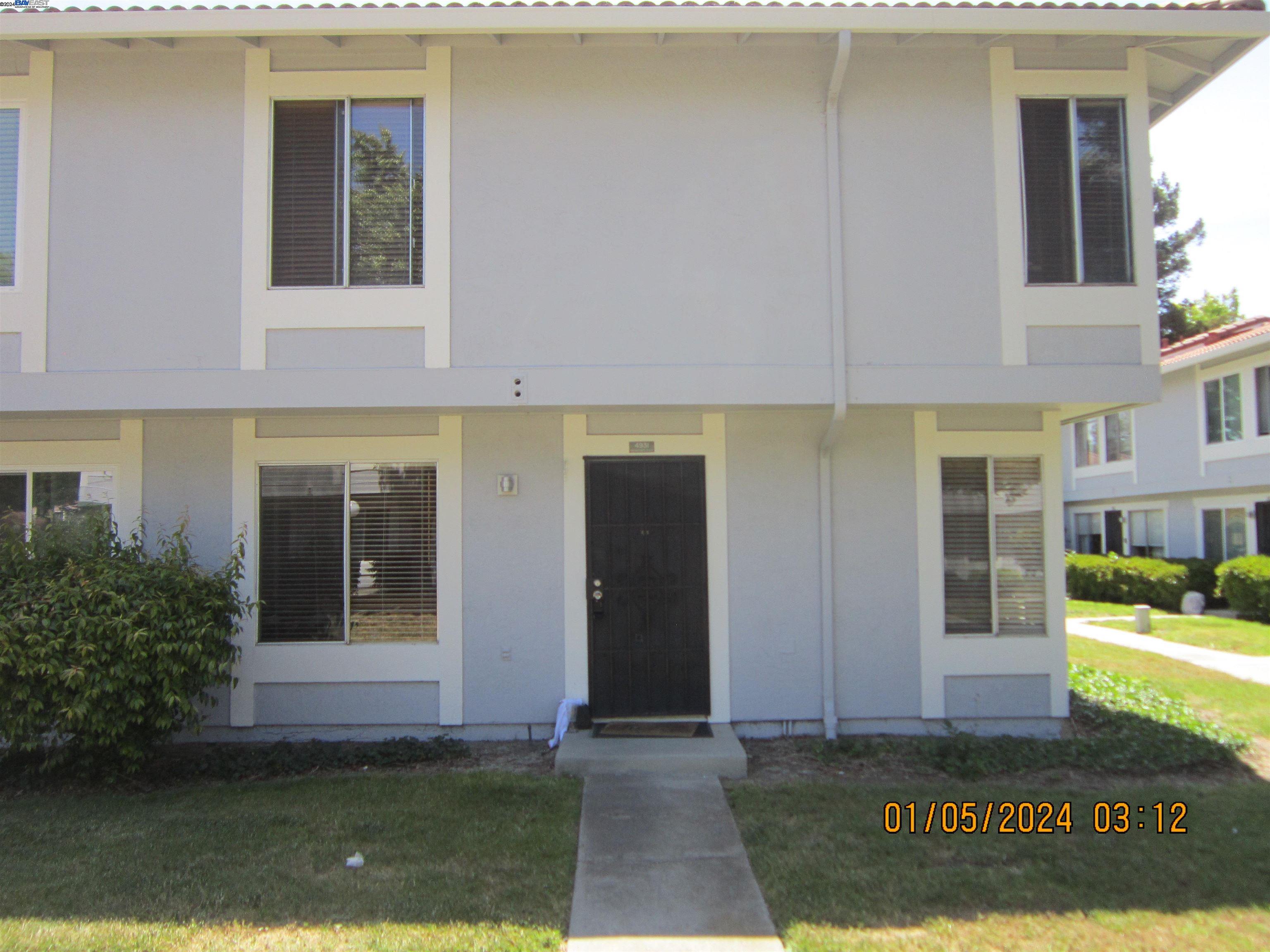 a view of front door of house with yard