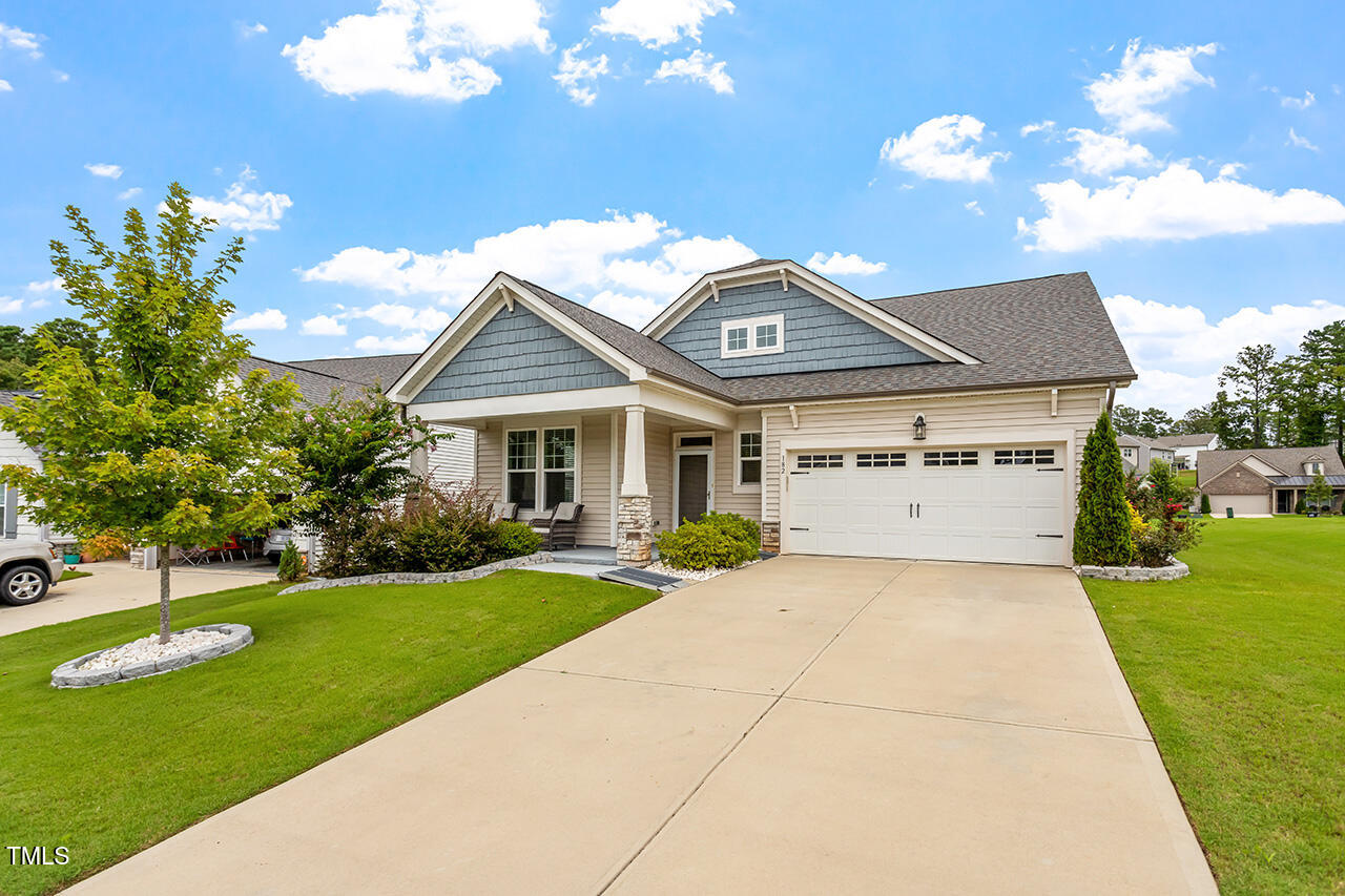 a front view of house with yard and green space