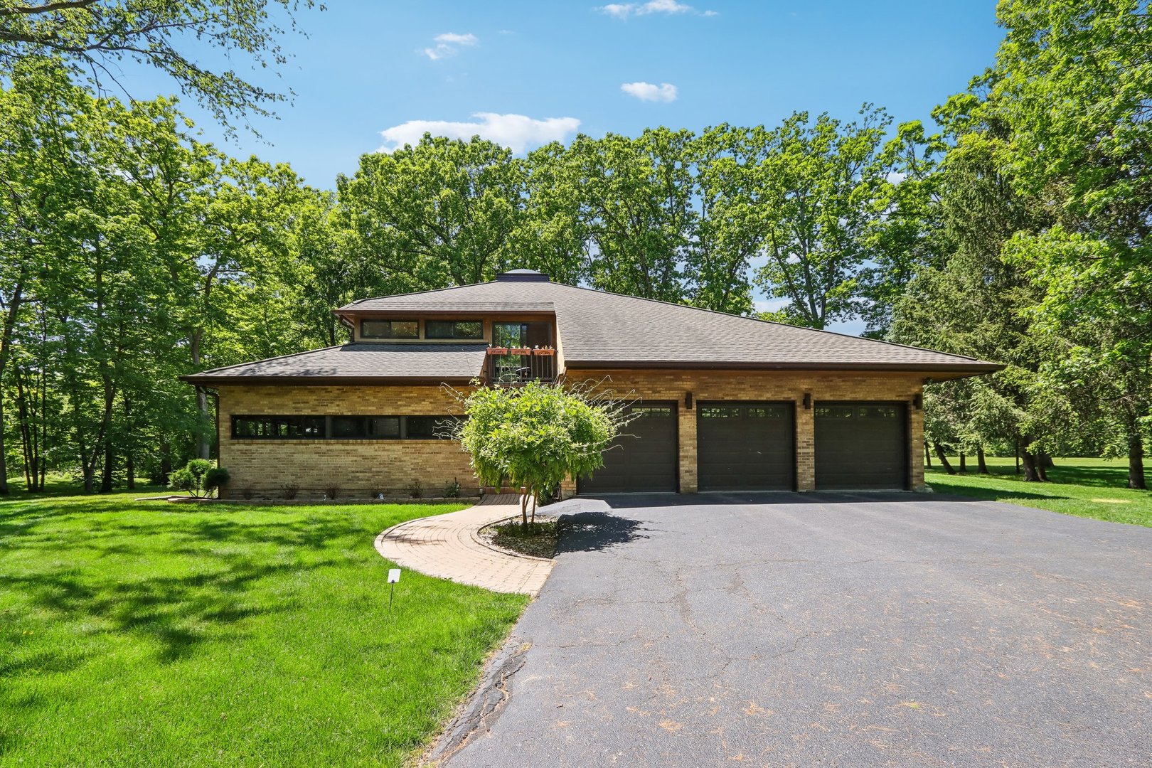 a front view of a house with a garden