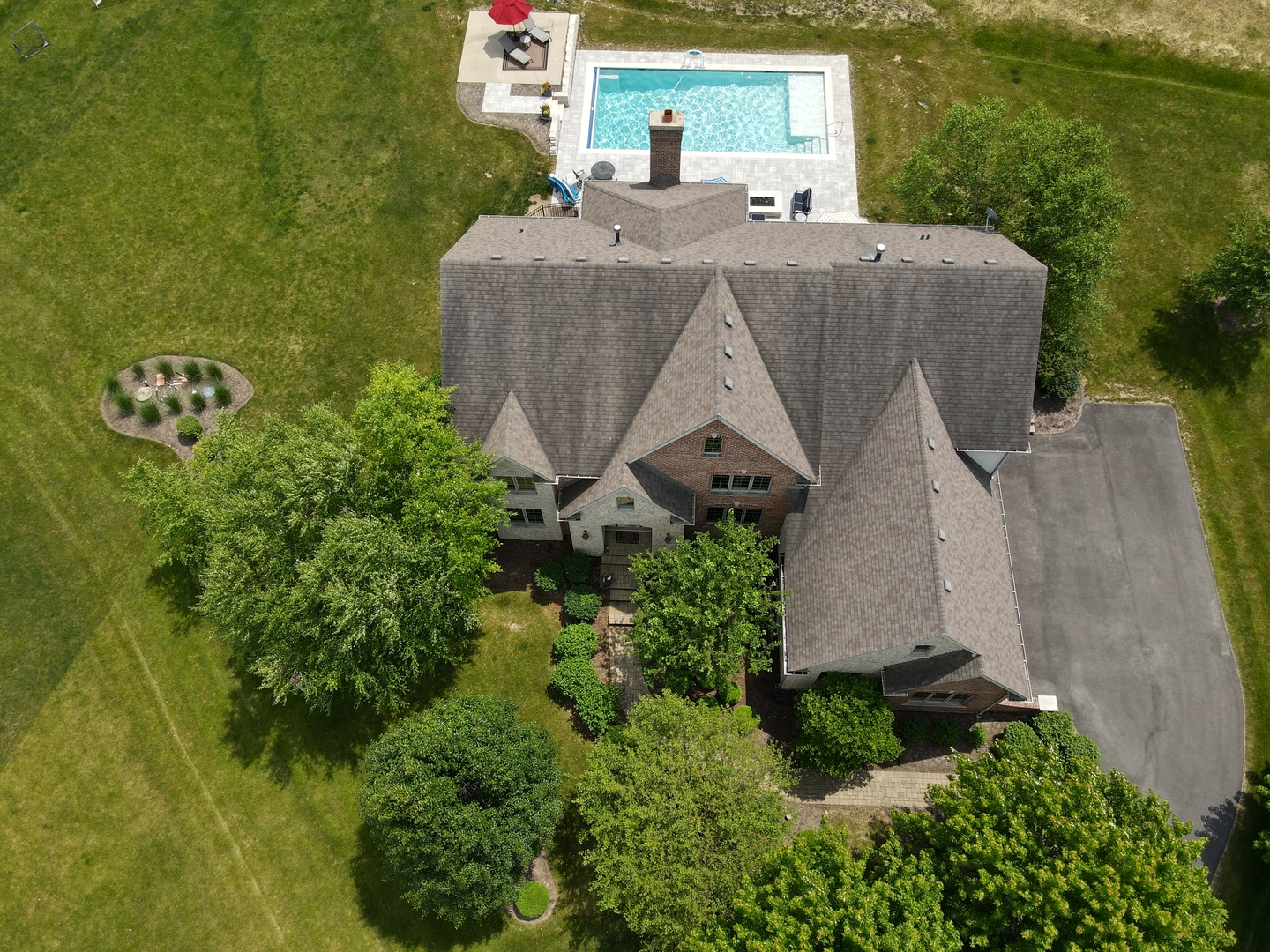 an aerial view of a house with a yard and lake view