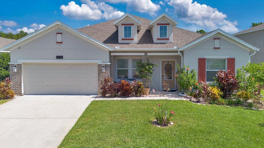 a front view of a house with a yard and garage