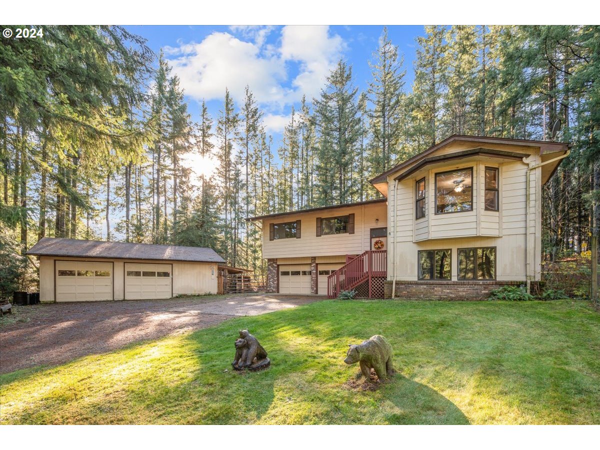 a view of a house with a big yard and large trees