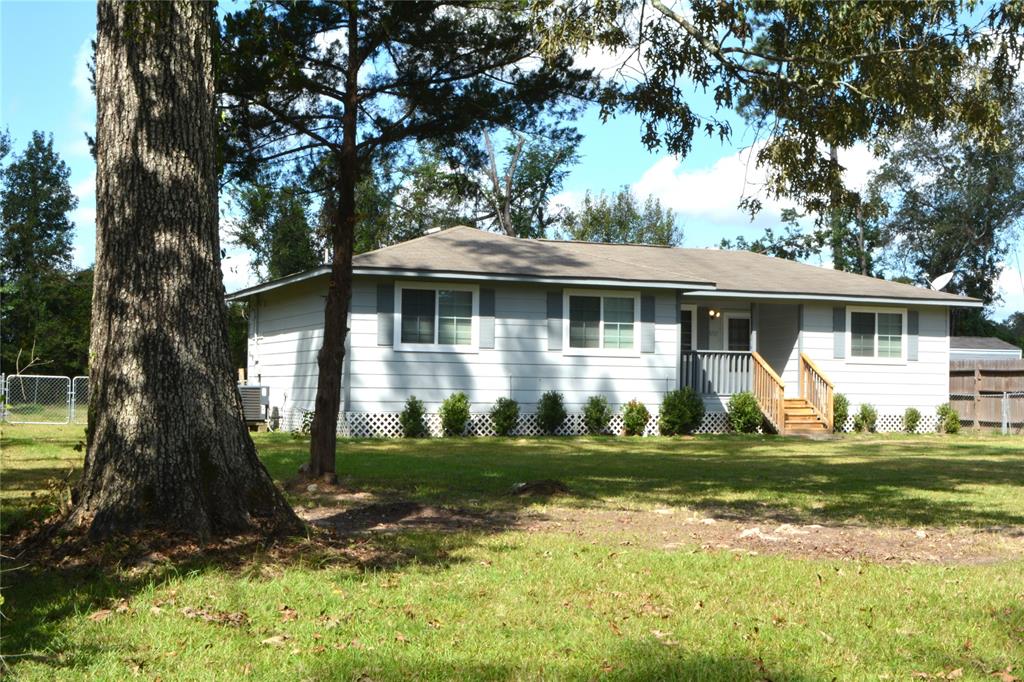 a front view of a house with a yard porch and outdoor seating