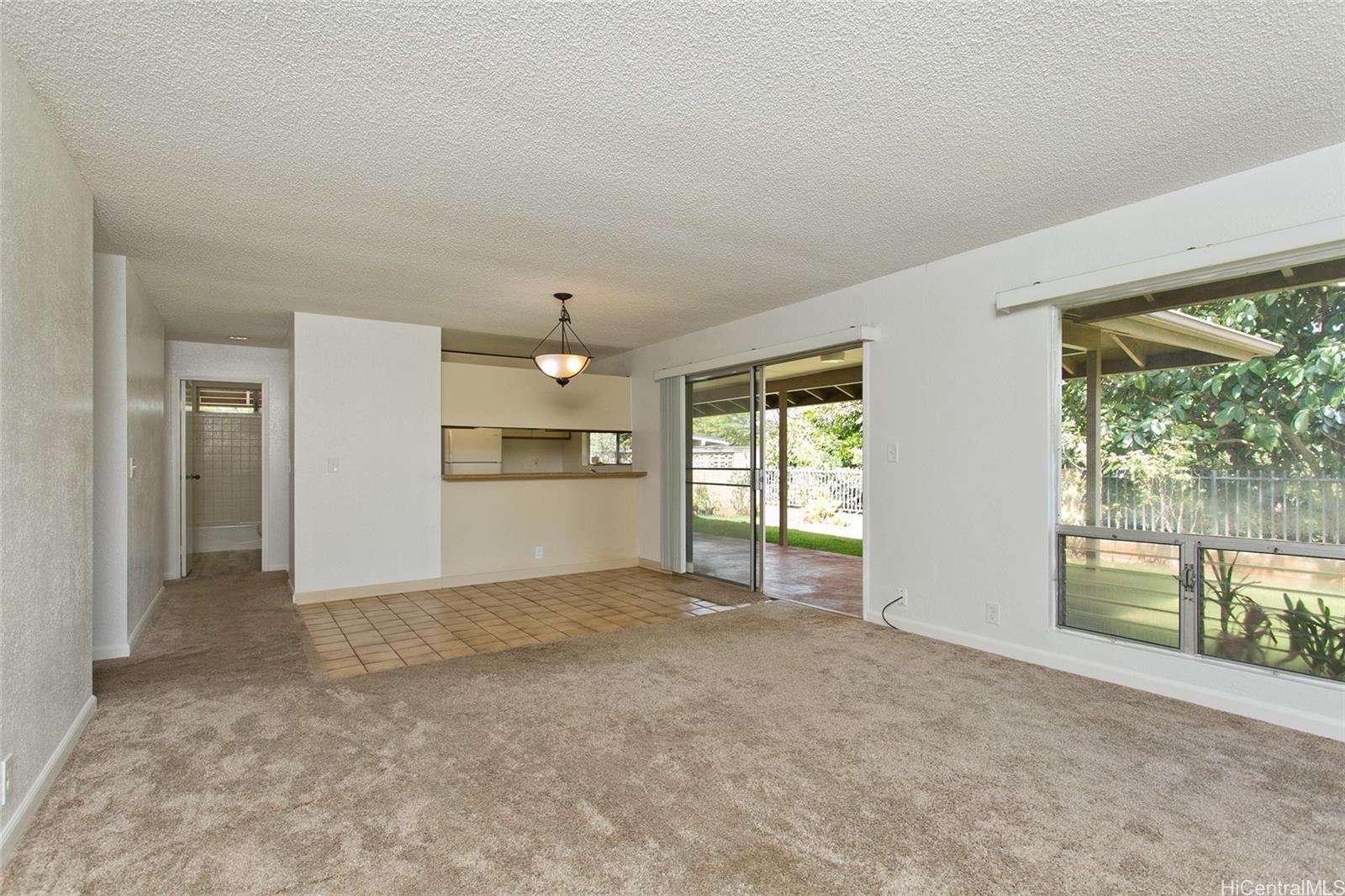 an empty room with windows and outdoor view