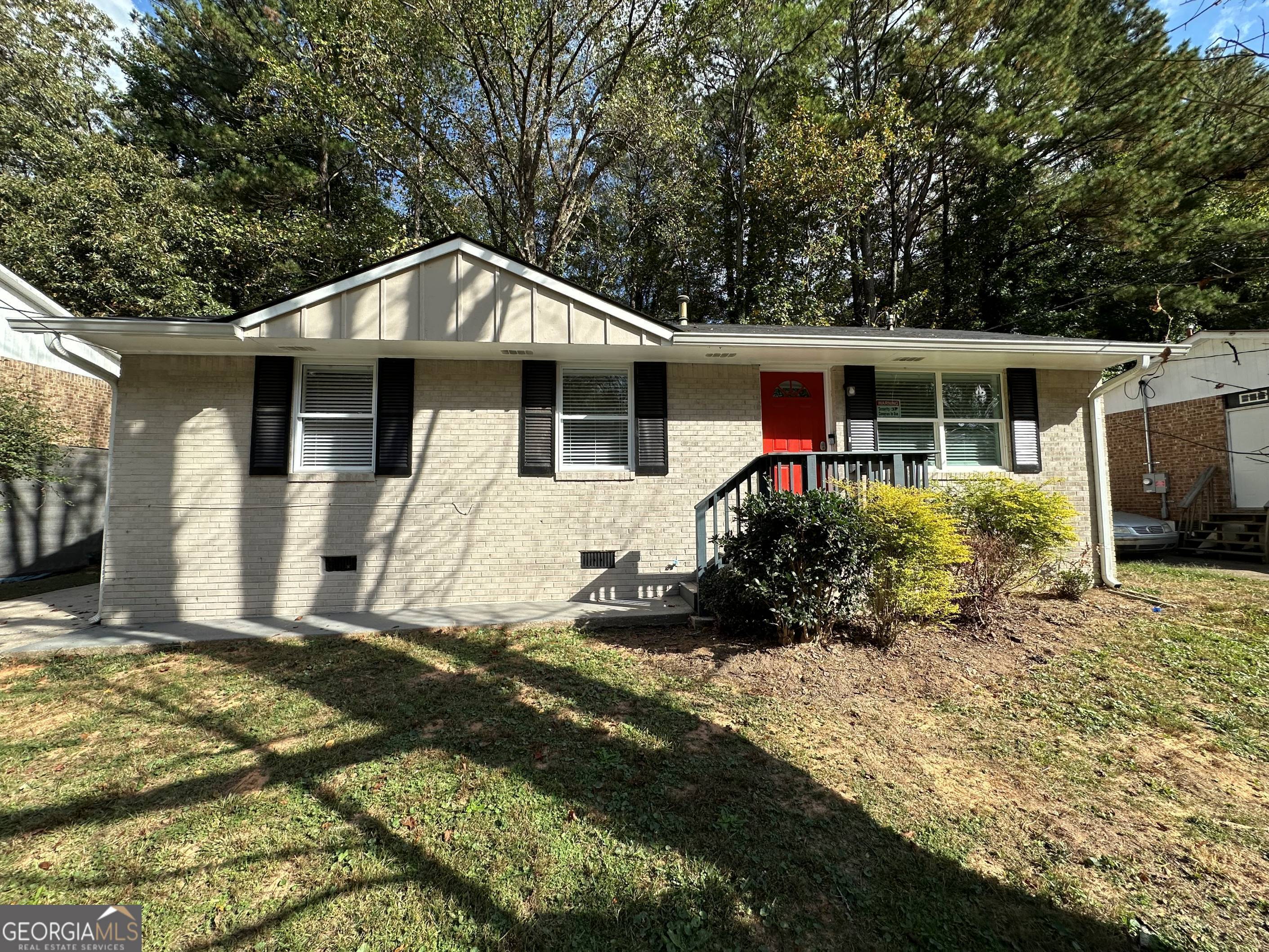 a front view of house with yard outdoor seating and barbeque oven