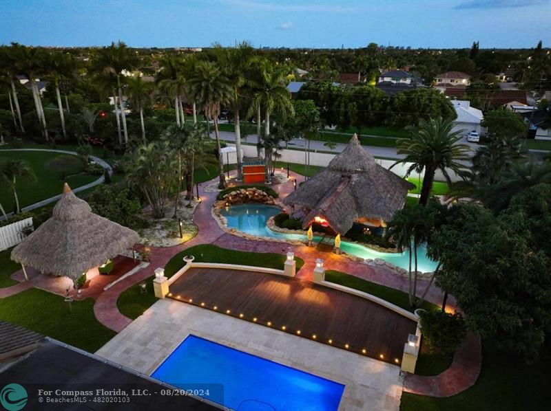 an aerial view of a house with a yard basket ball court and outdoor seating