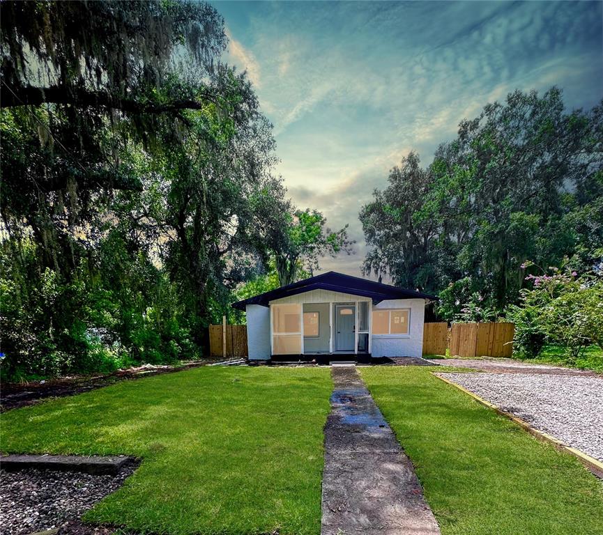 a front view of house with a garden