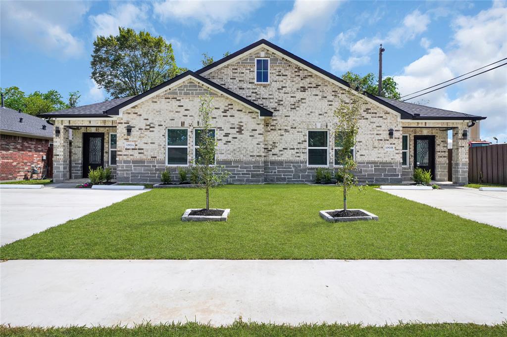 Welcome Home! The welcoming front porch, framed by elegant landscaping, sets the tone for the home’s sophisticated interior.