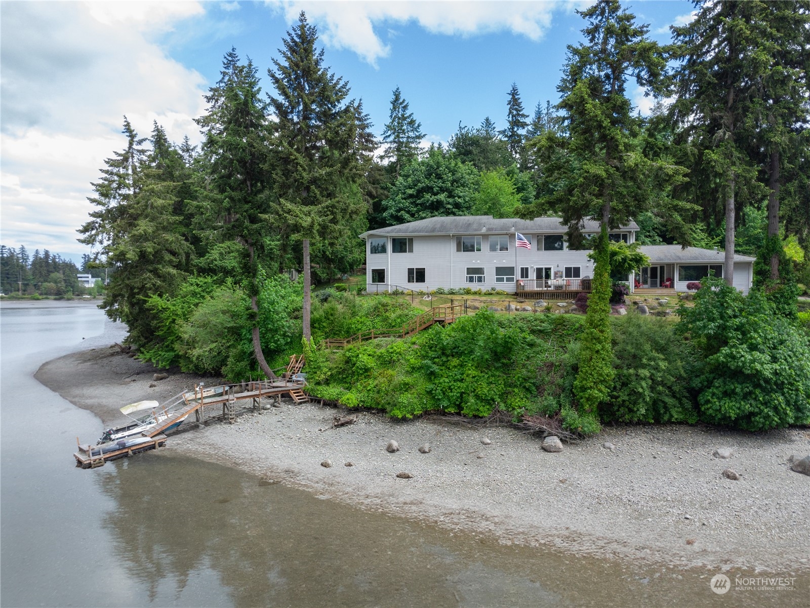 an aerial view of a house with a yard and lake view