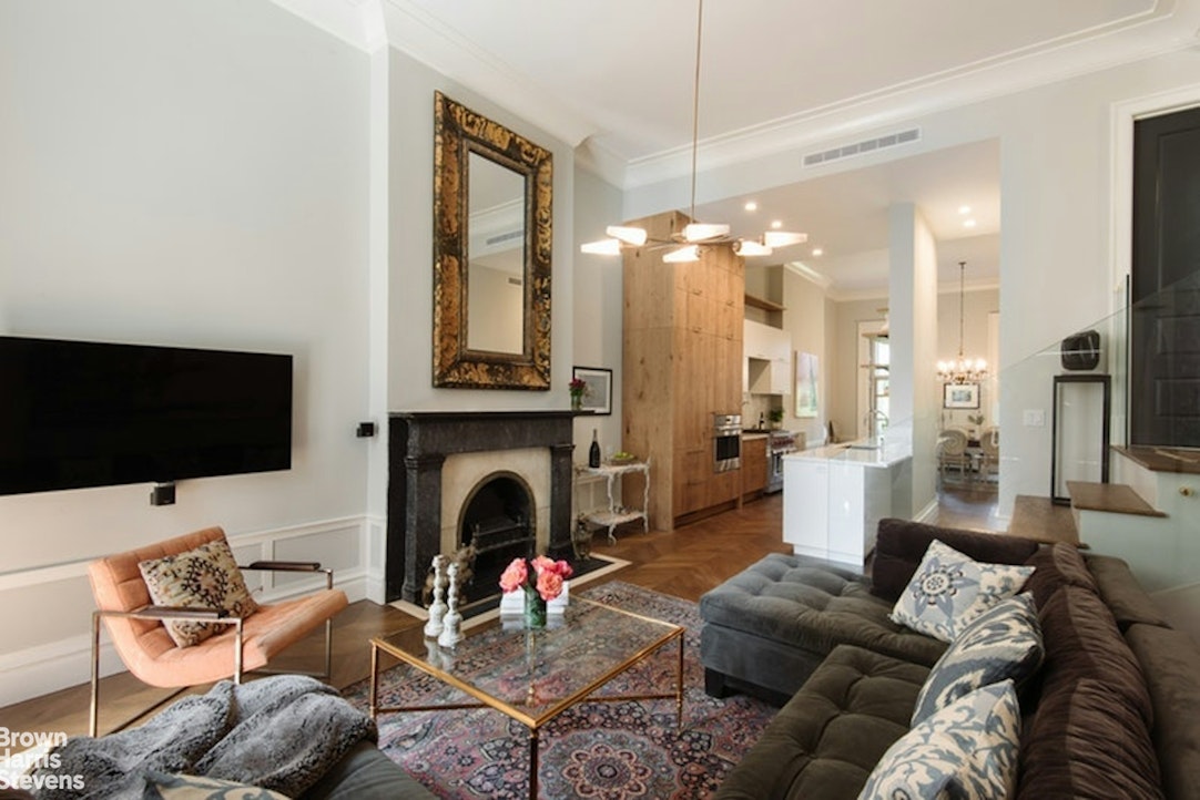 a living room with furniture a flat screen tv and a fireplace