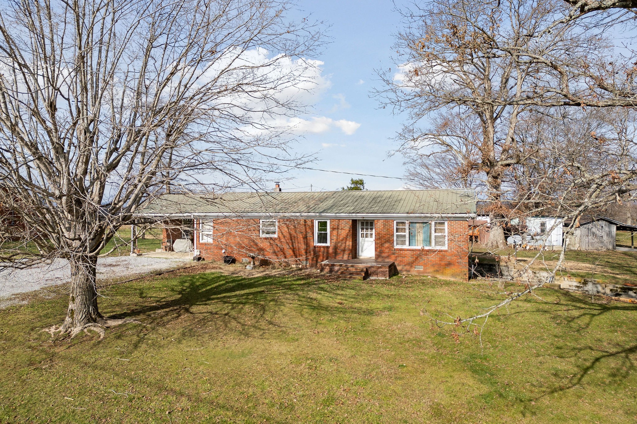 a front view of residential houses with yard and trees