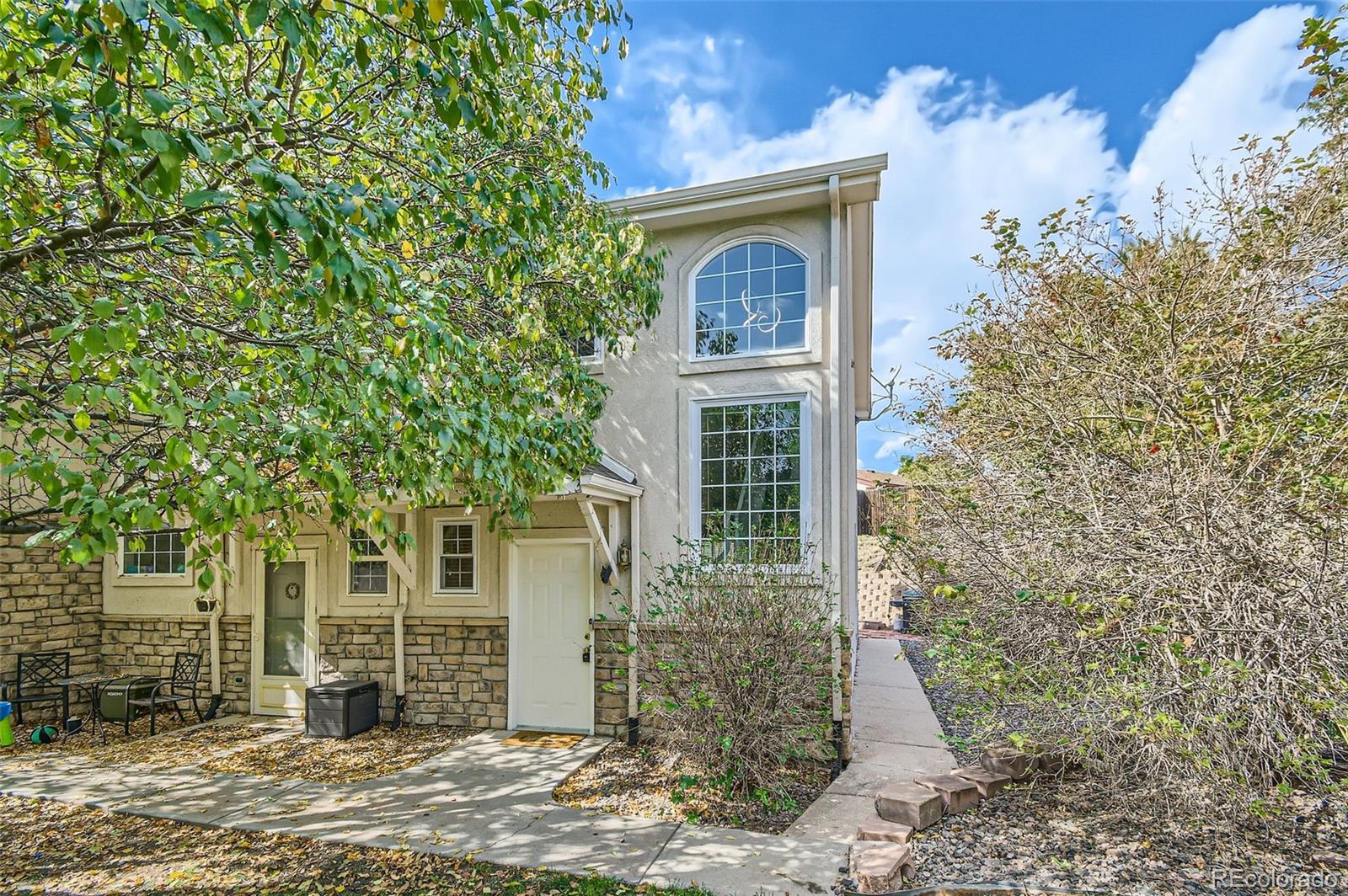 front view of a house with a tree