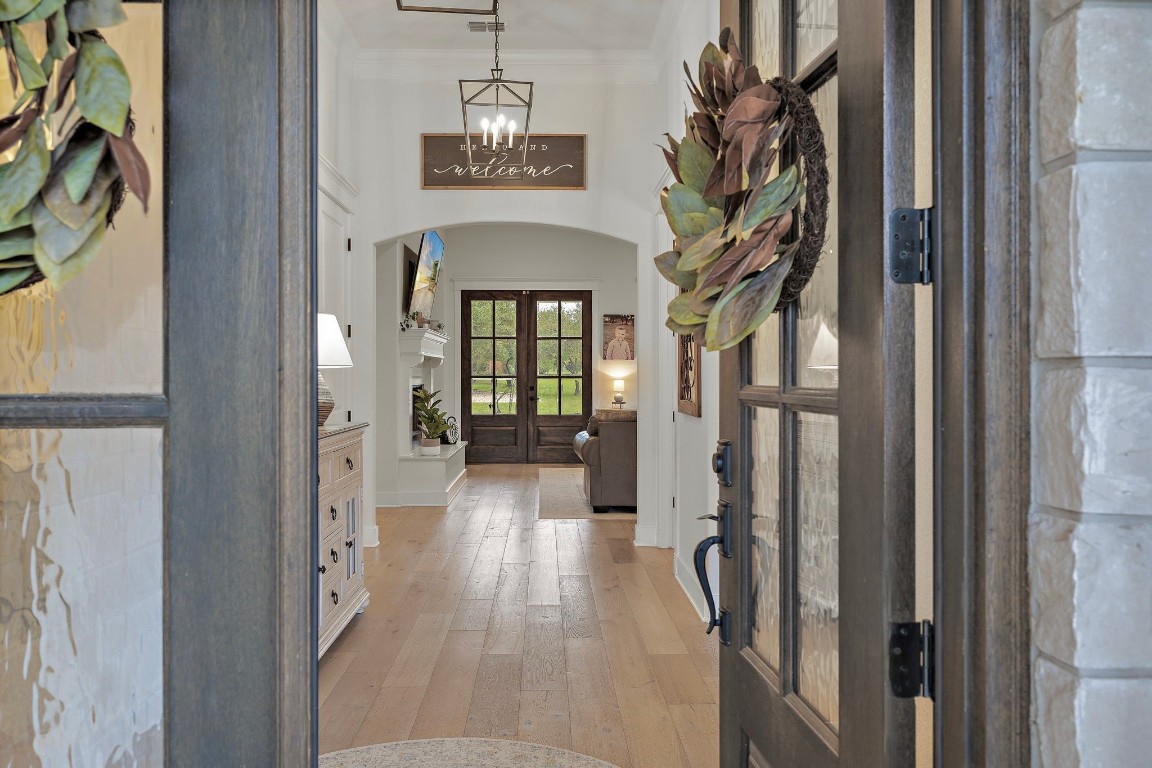 a view of a hallway with wooden floor and entryway